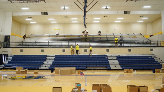 The Tutt Construction crew of Billings, Mont. work to assemble new bleachers in the Buff Gym last week. Lisa Kunkel
