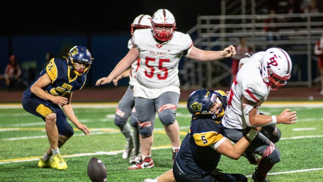 Greybull Buff Will Harlow (5) takes down a Big Piney Puncher, creating an opening for Carter Peasley, far left, to make a fumble recovery at Friday night’s home game. Avery howe