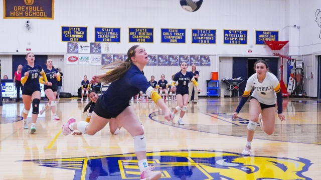 Senior Ellie Holloway reaches to save the ball as her teammates watch in anticipation during last Friday afternoon’s homecoming game in the Buff Gym. Lisa Kunkel