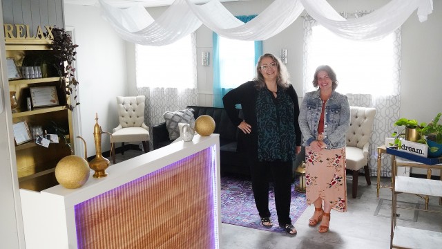 Danae Bales, left, and Lacey Ford stand in the waiting lounge of Oiloveu Wellness Spa in downtown Greybull Tuesday morning. Lisa Kunkel